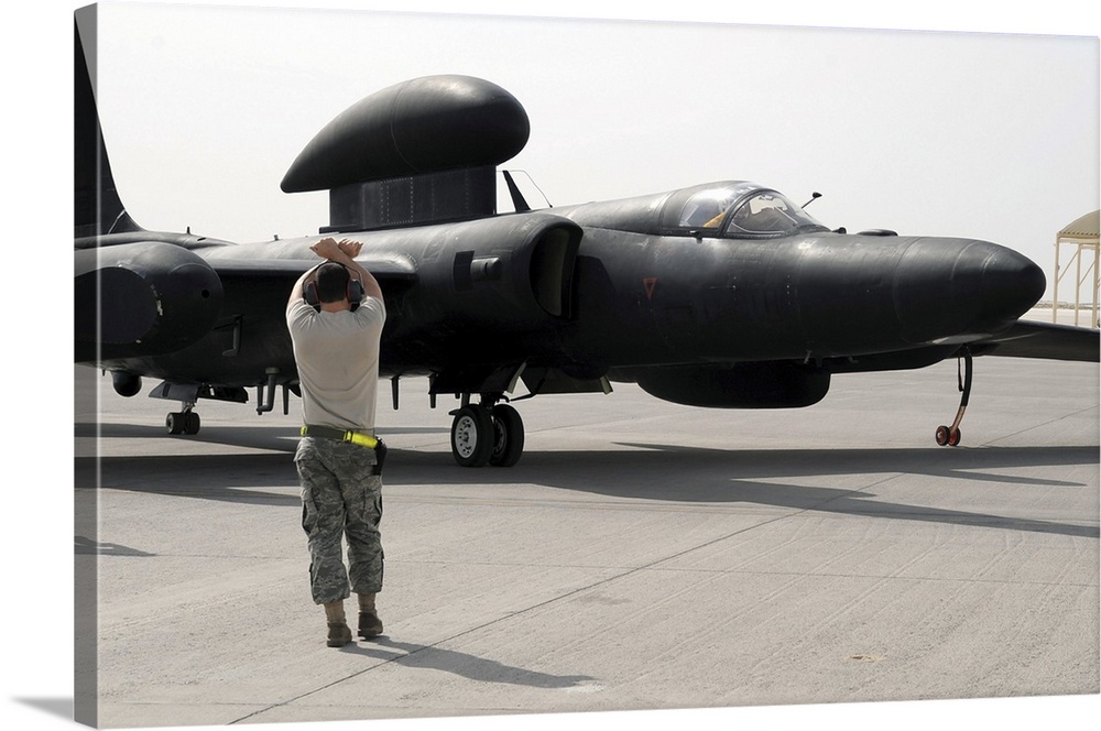 April 5, 2010 - A maintenance airman guides a pilot in a U-2 Dragon Lady aircraft to a parking space at a non-disclosed ba...