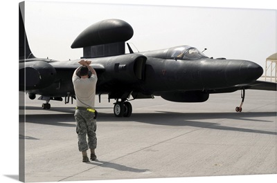 A Maintenance Airman Guides A Pilot In A U-2 Dragon Lady Aircraft To A Parking Space