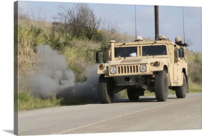 A mock improvised explosive device explodes in the window of a humvee