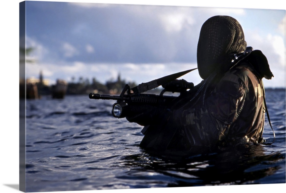 A Navy SEAL emerges from underwater during a training exercise