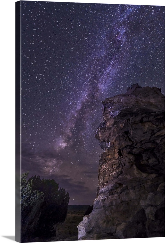 A rocky hoodoo stands against the night sky as the Milky Way sets near Black Mesa, Oklahoma.