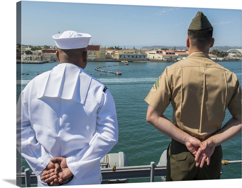 San Diego, California, August 23, 2013 - A Sailor and Marine man the rails aboard the amphibious assault ship USS Boxer (L...