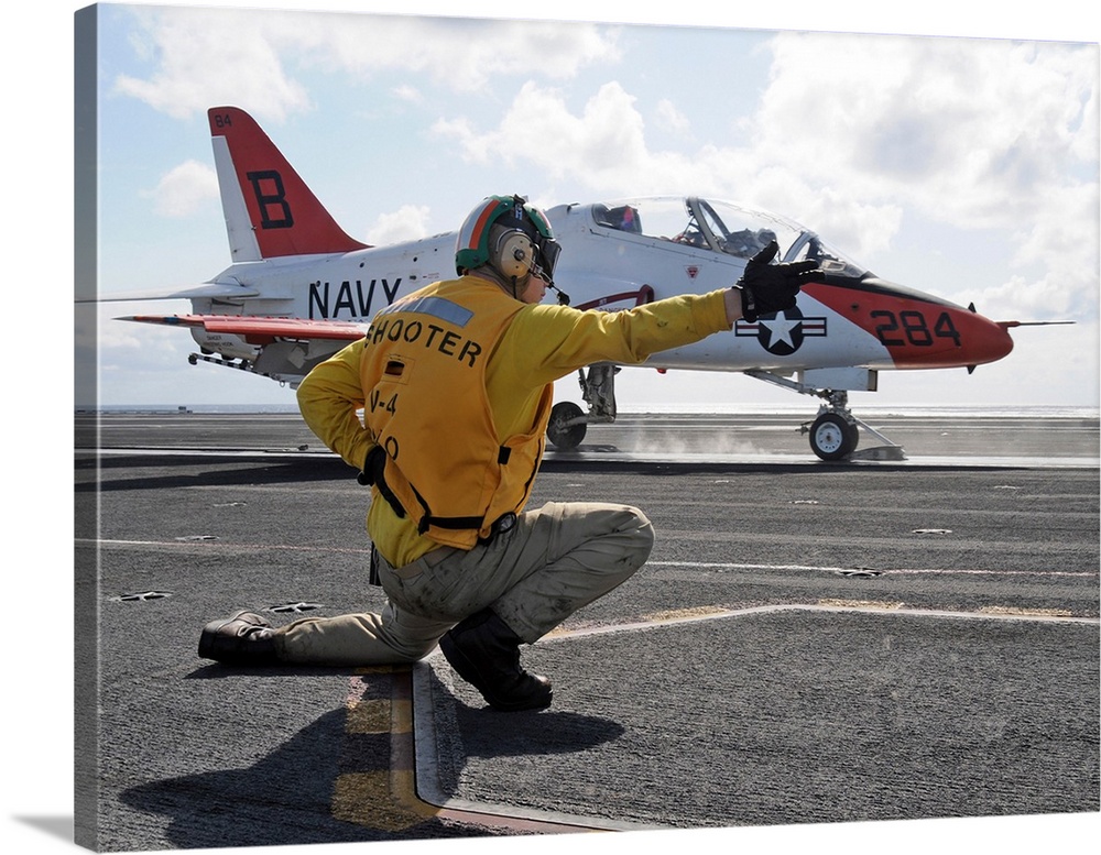A shooter launches a T-45 Goshawk training aircraft.