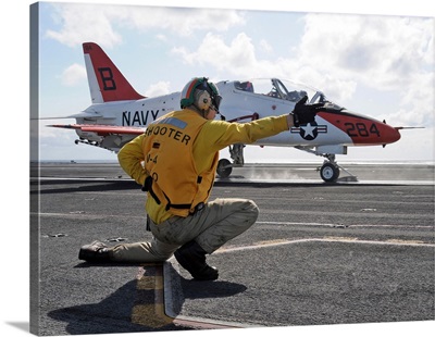 A shooter launches a T-45 Goshawk training aircraft