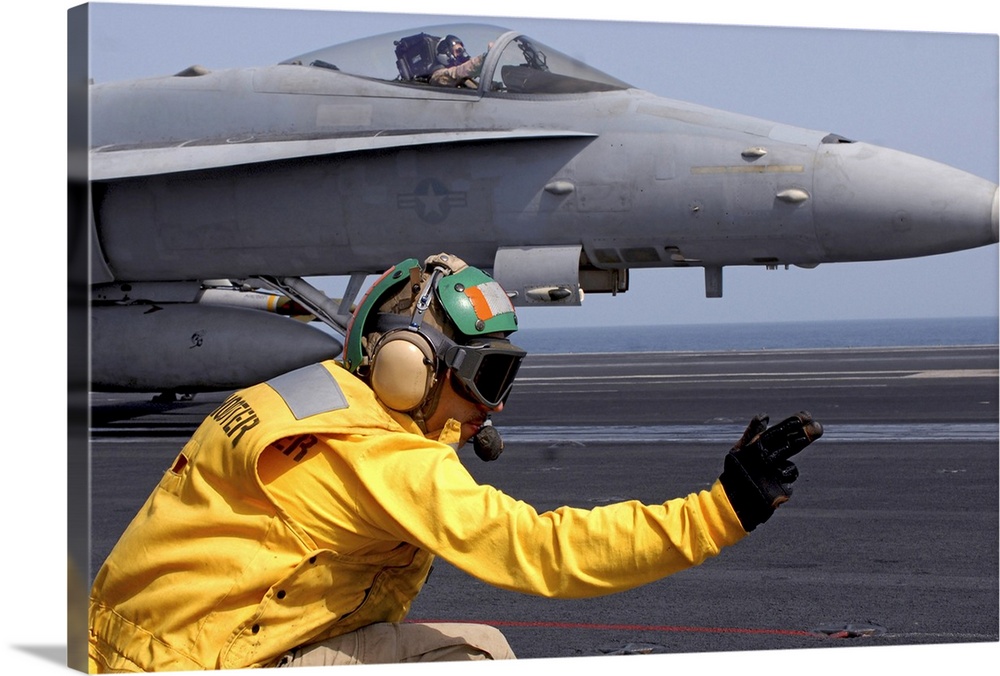 North Arabian Sea, September 1, 2008 - A shooter gives the signal to launch an F/A-18C Hornet assigned to the Stingers on ...