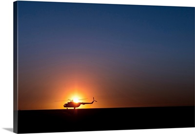 A Sikorsky S-61L Mk II helicopter taxis on the runway during sunrise