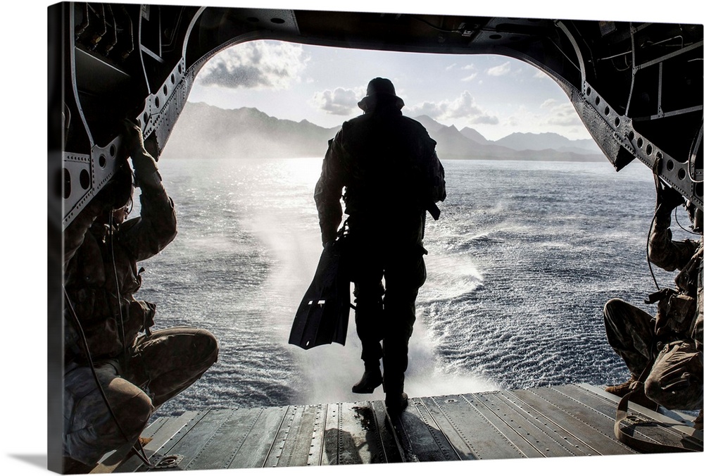 A soldier conducts a combat dive mission off the back of a CH-47 Chinook.