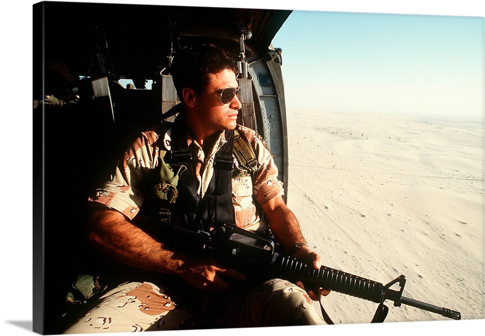 A soldier scans the horizon from inside a helicopter during Operation Desert Storm.