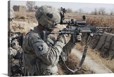 A U.S. Army soldier looks through the scope of his M-14 sniper rifle