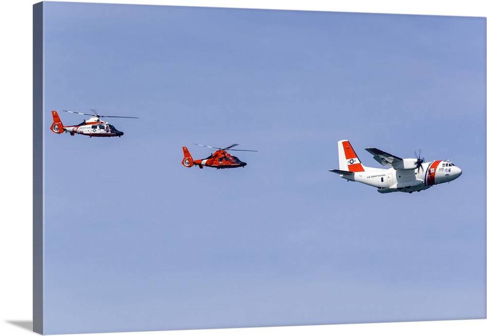 A U.S. Coast Guard C-27J makes a flypast in formation with two Eurocopter MH-65 Dolphin helicopters during Fleet Week at S...