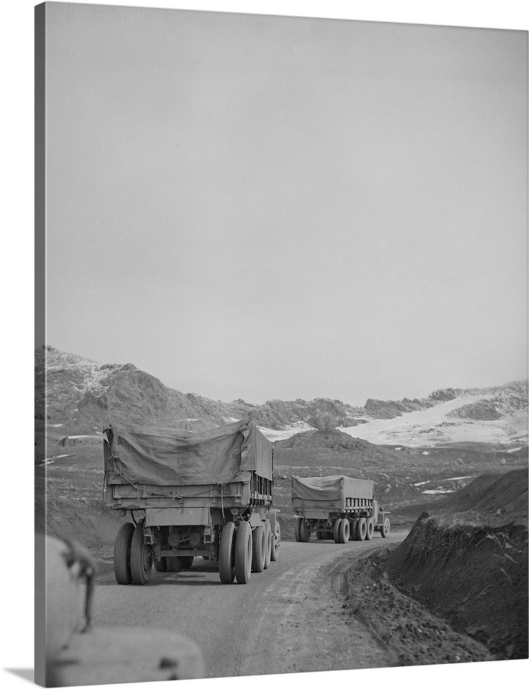 A United States Army truck convoy carrying supplies for Russia climbing a snowbound mountain pass somewhere in the Persian...