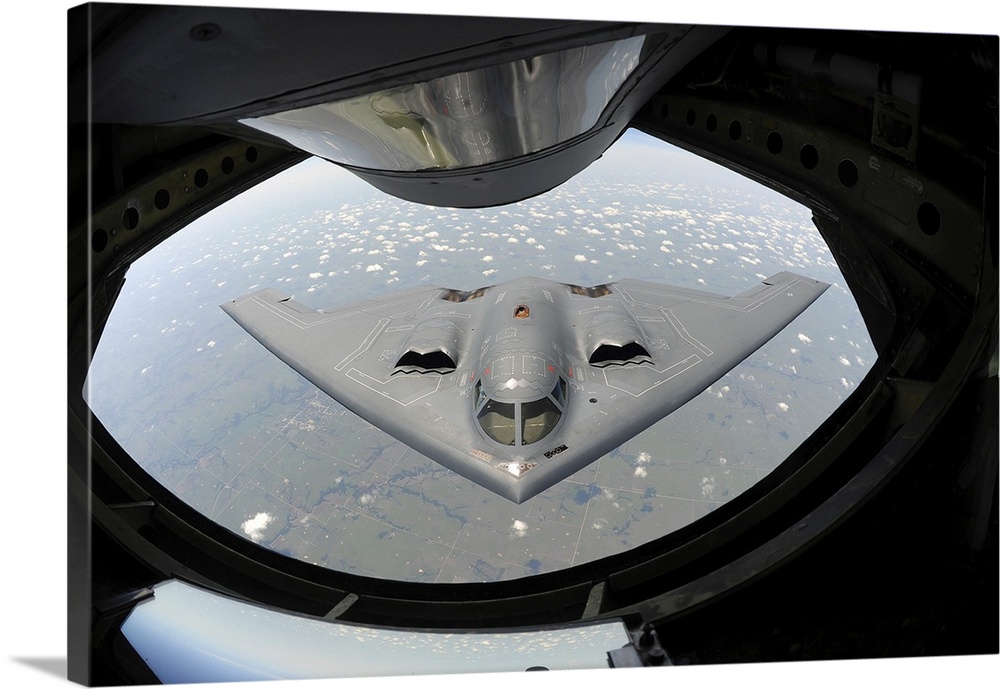August 1, 2013 - A U.S. Air Force B-2 Spirit bomber aircraft approaches the rear of a KC-135 Stratotanker aircraft before ...