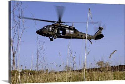 A US Army UH60 Black Hawk helicopter prepares to pick up soldiers