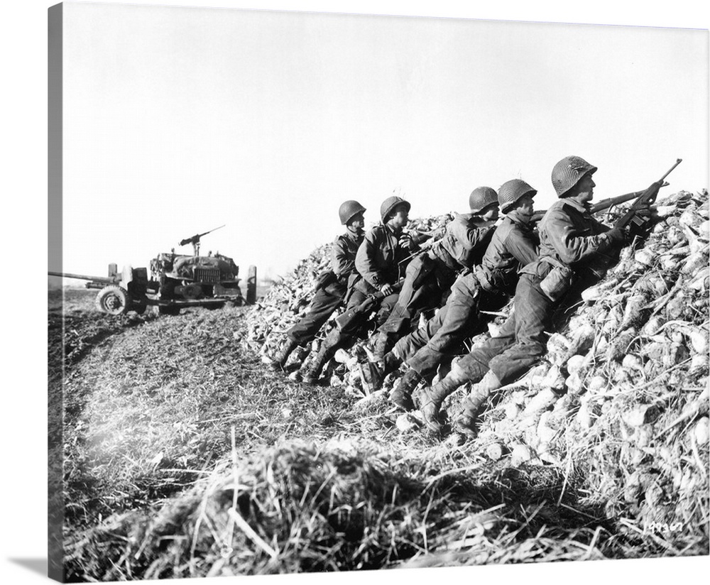 A U.S. Infantry anti-tank crew fires on Nazis somewhere in Holland, 1944.