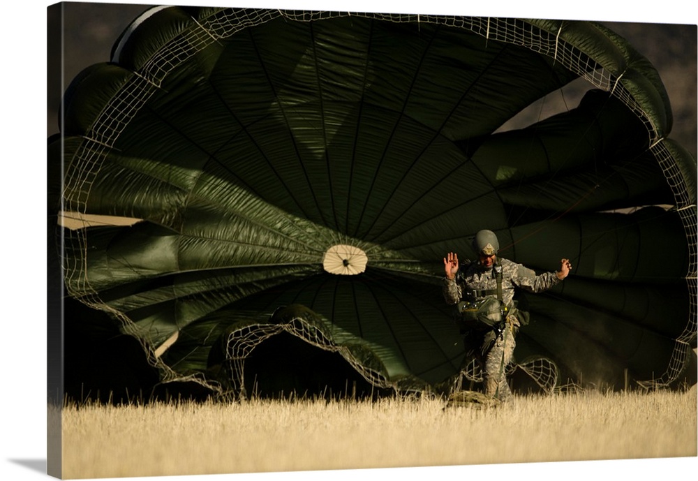 A U.S. soldier collapses his parachute after a static line jump.