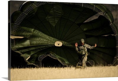 A US soldier collapses his parachute after a static line jump