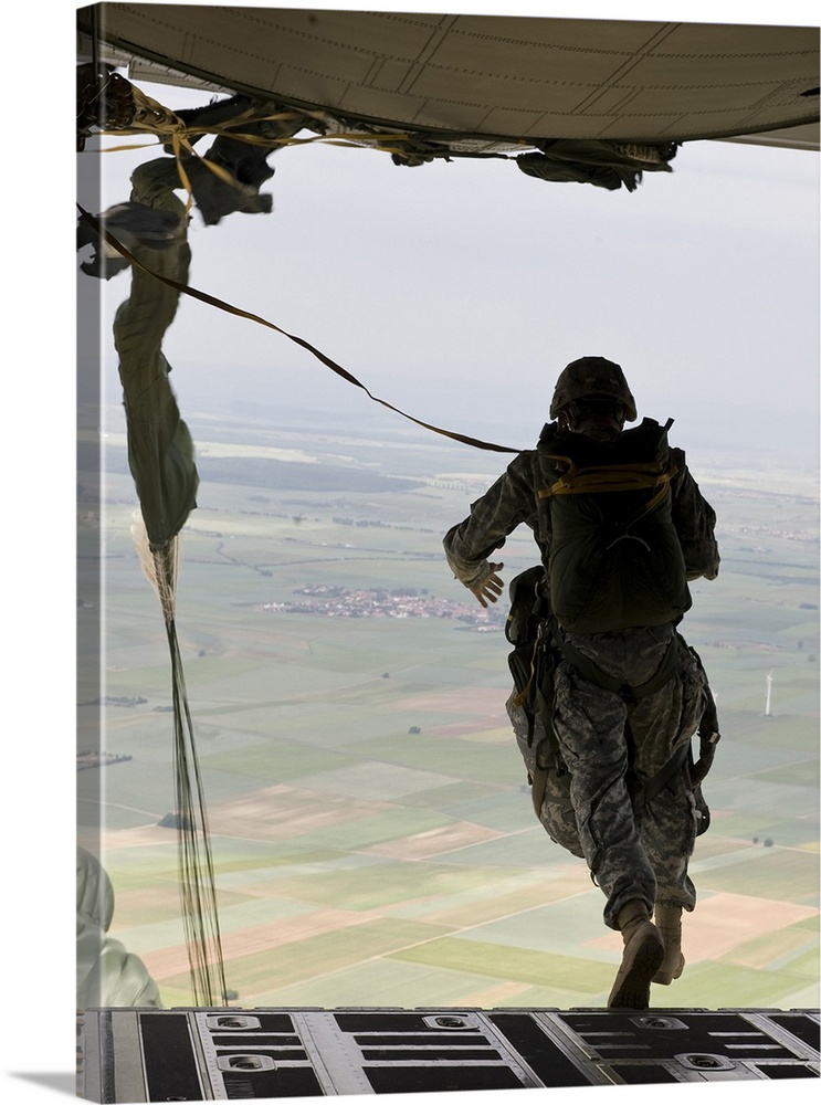 A U.S. soldier jumps out of a C-130J Super Hercules.