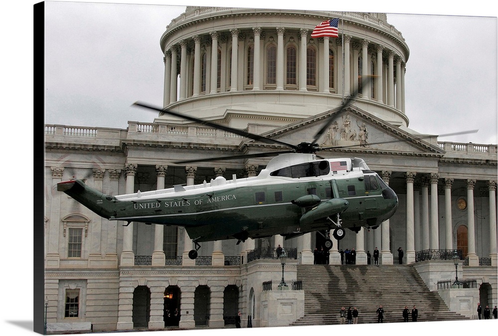 A VH-60 helicopter lands in front of the Capitol building.