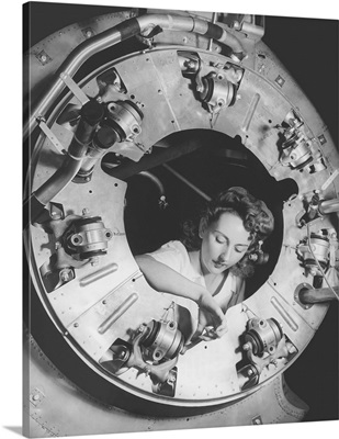 A woman assembles part of the cowling of a B-25 bomber motor, circa 1942
