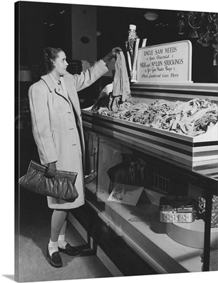A woman donates her silk stockings during World War II