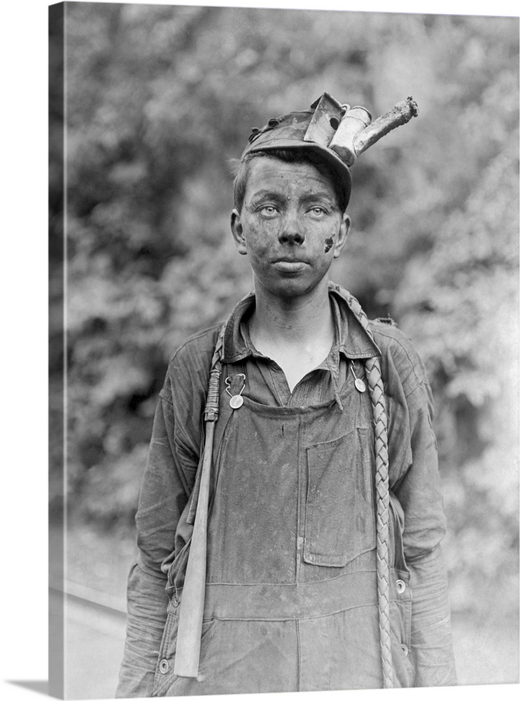 A young boy covered in soot after a day of work in the coal mines of West Virginia in 1908.