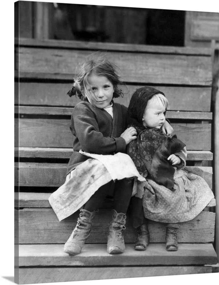 A young child tending to her younger sister in Bayou La Batre, Alabama.