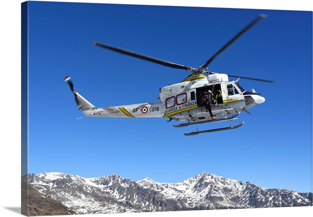 AB.412 helicopter from Guardia di Finanza flying over the Alps.