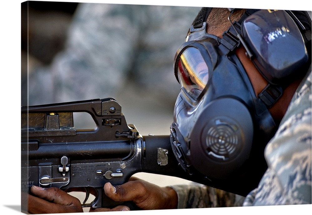 July 26, 2011 - Air Force Basic Military Training trainee fires at his target while wearing his gas mask during combat arm...