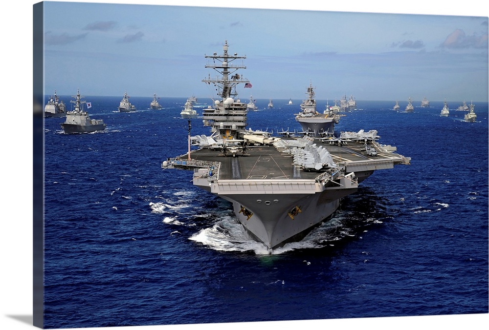 The Nimitz-class aircraft carrier (CVN-76) leads a mass formation of ships from Korea, Taiwan, Japan, Singapore, France, C...