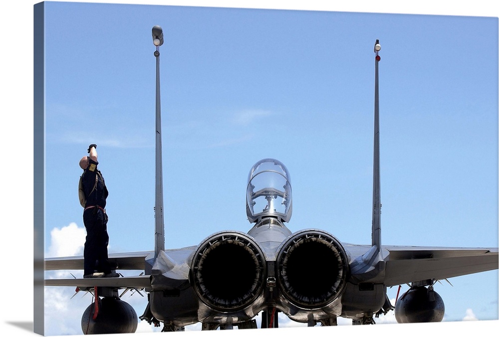 Airman checks an F-15E Strike Eagle for airframe damage.
