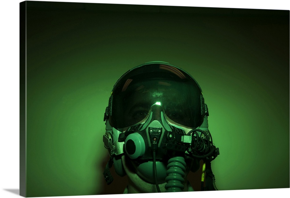 Airman donning flight helmet and night vision goggles.