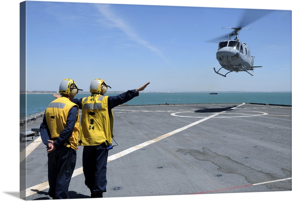 Atlantic Ocean, May 5, 2010 - Airmen direct a Spanish navy AB-212 helicopter onto the flight deck of the amphibious dock l...