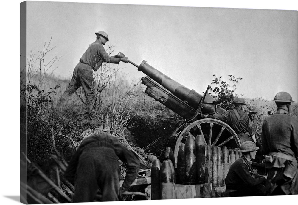 American artillery soldiers reloading a 155mm howitzer cannon during France in WW1.