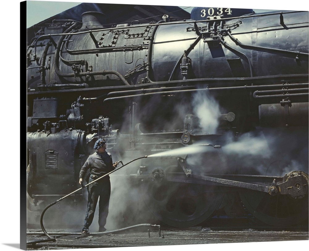 American history photograph of a woman giving a Class H Locomotive a steam bath.
