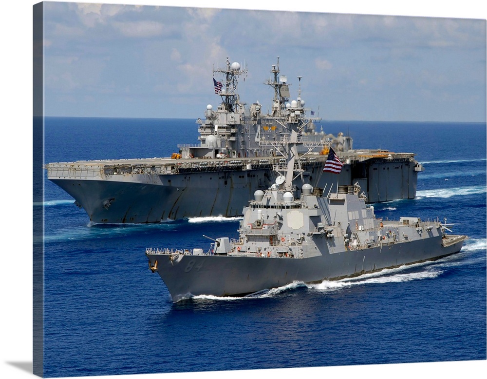 Amphibious assault ship USS Nassau and guided missile destroyer USS Bulkeley transit the Atlantic Ocean.