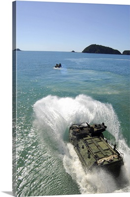 Amphibious Assault vehicles exit the well deck of the USS Denver