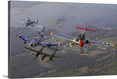 An A-10 Thunderbolt, F-86 Sabre, P-38 Lightning and P-51 Mustang in flight