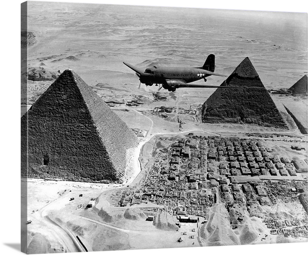 An Air Transport Command plane flies over the pyramids in Egypt, 1943.