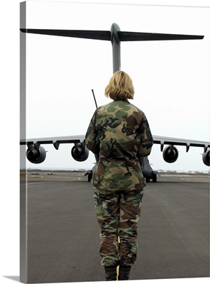 An airfield manager greets an arriving C-17 Globemaster III