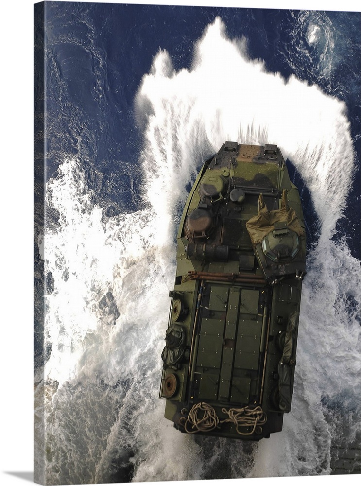 An amphibious assault vehicle exits the well deck of USS Essex.