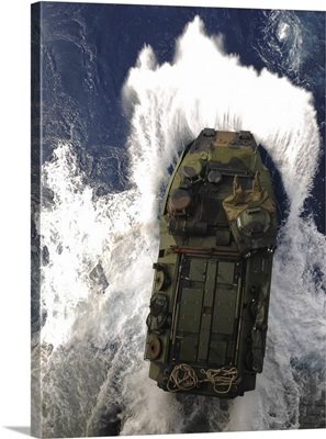 An amphibious assault vehicle exits the well deck of USS Essex