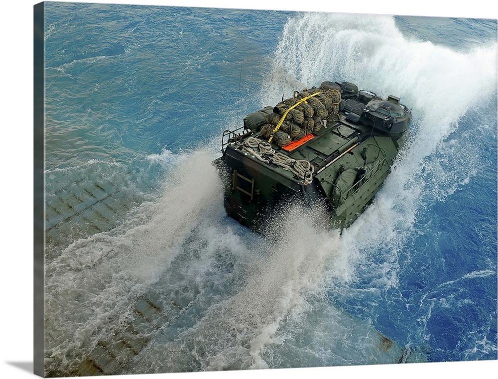 An amphibious assault vehicle exits the well deck of USS Fort McHenry.