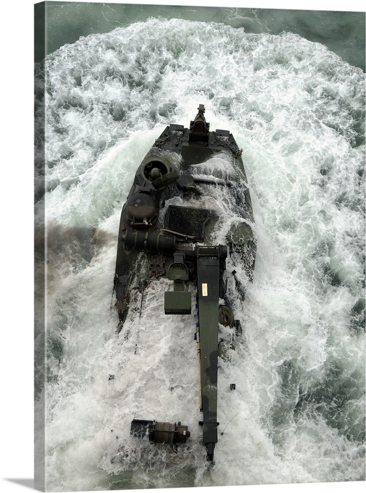 An amphibious assault vehicle leaves the well deck of USS Iwo Jima.