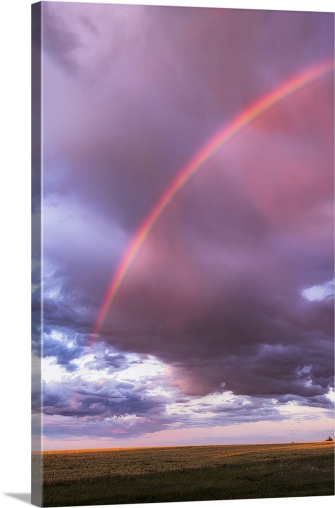 An Arc Of A Nearly Semi-Circular Rainbow At Sunset With Cloudy Sky, Alberta, Canada