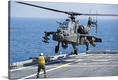 An Army AH-64D Apache helicopter prepares to land aboard USS Ponce