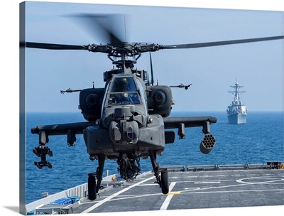 An Army AH-64D Apache helicopter takes off from USS Ponce