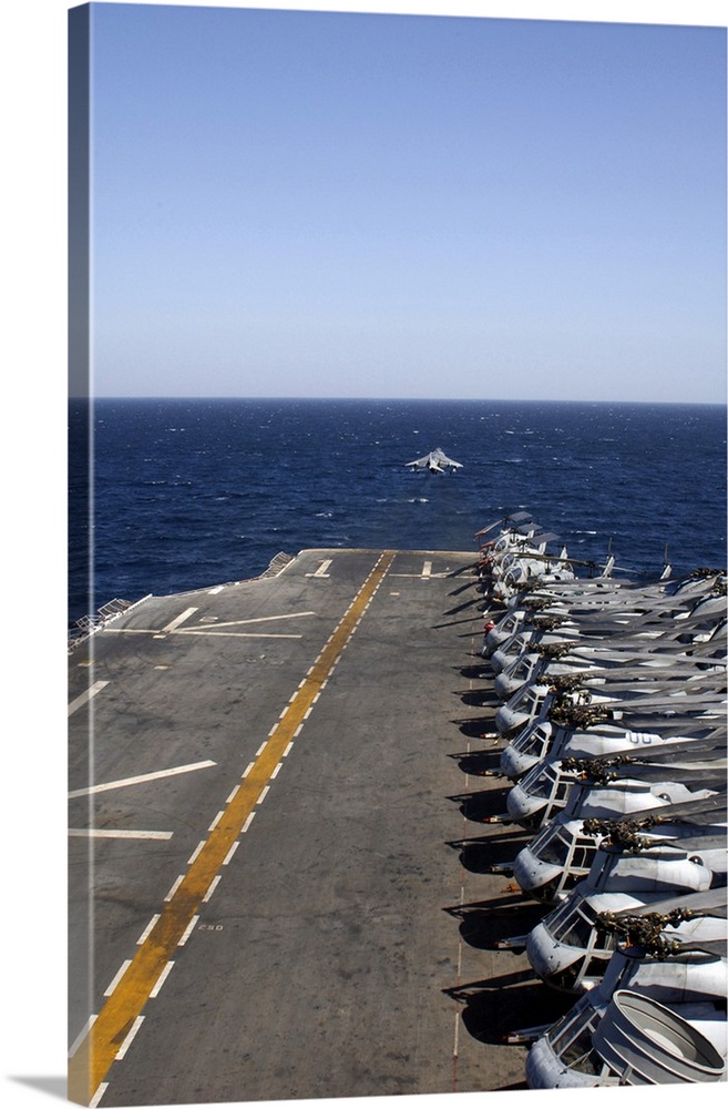 An AV-8B takes off from the flight deck of USS Tarawa lined with helicopters.