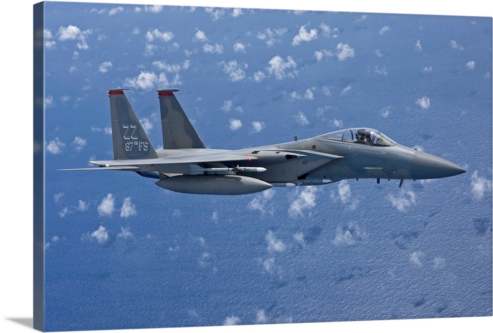 An F-15 Eagle from the 67th Fighter Squadron in Kadena Air Base, Okinawa, Japan, flies over the Pacific Ocean during a tra...