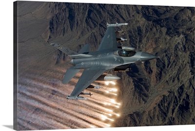 An F-16 Fighting Falcon releases flares during a training mission