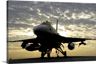 An F-16 Fighting Falcon sits tethered to the hot cargo pad at Joint Base Balad, Iraq